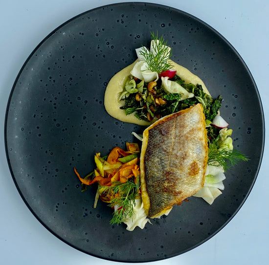 seared seabass plated at a galley gang yacht chef course